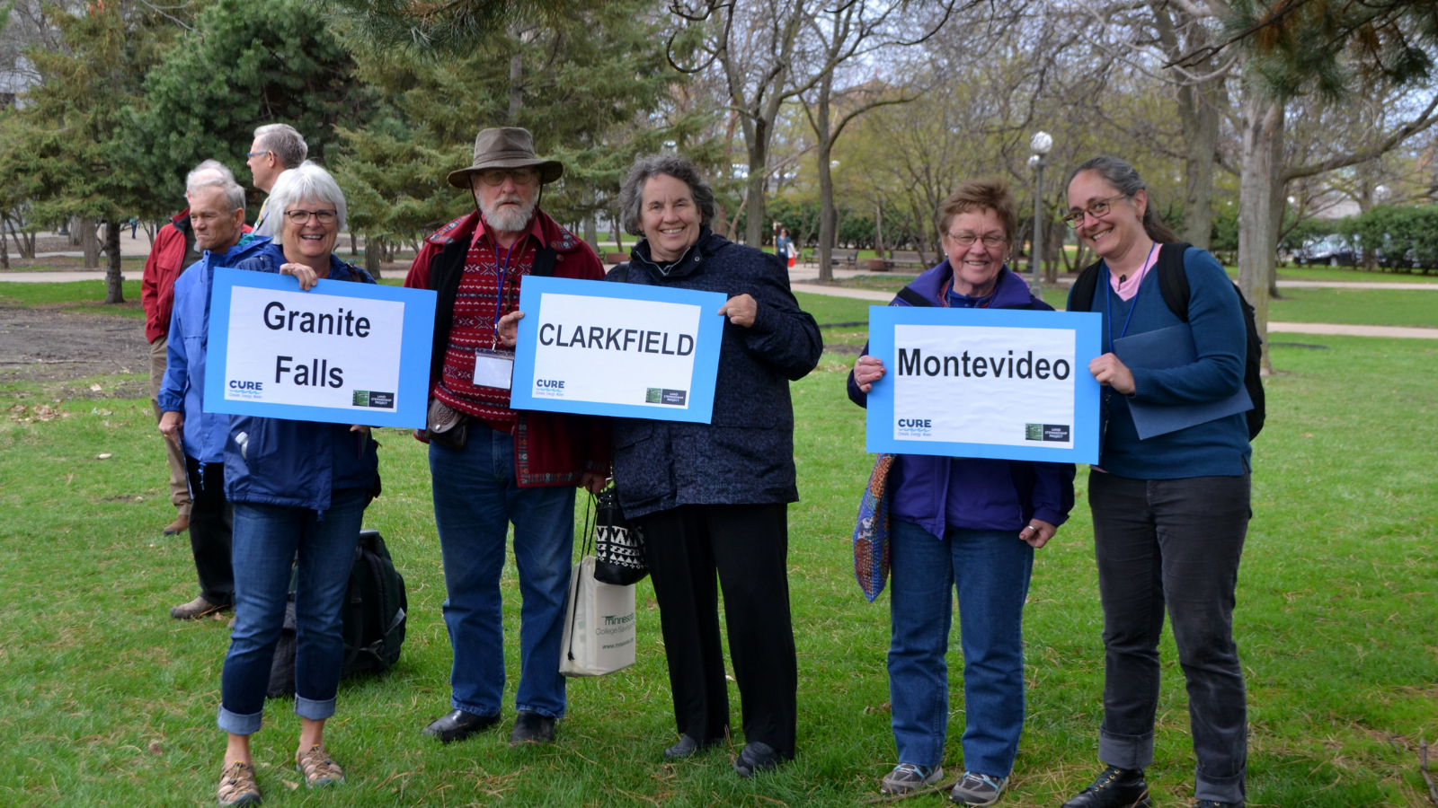 CURE members with signs of their towns at Water Action Day.
