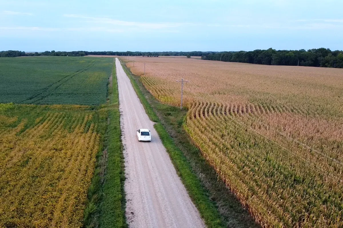 Electric Car driving down a gravel road