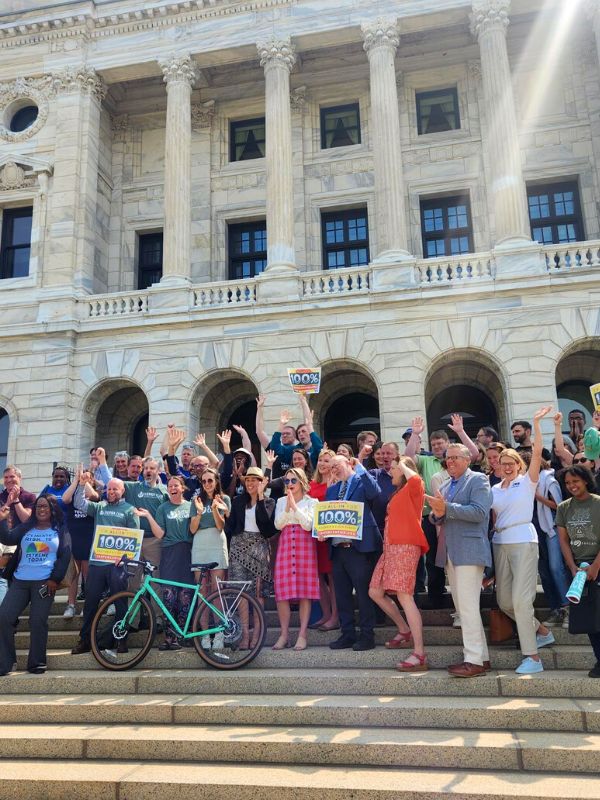 People celebrating the budget bill signing on the steps of the Minnesota State Capitol