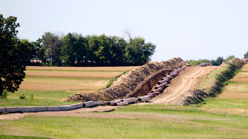 Pipeline being constructed through farmland