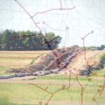 Pipeline construction through a farm field with a CO2 pipeline map overlaid on top.