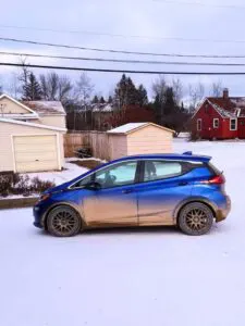 Dirty Chevy Bolt EV in winter in Ely, MN