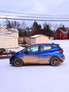 dirty Chevy Bolt EV in winter in Ely, MN