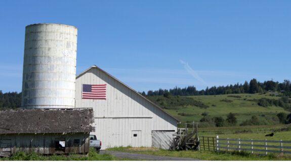 barn with flag and silo