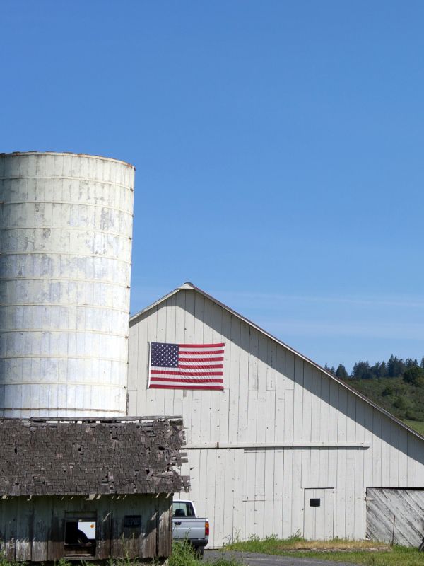 Barn with a flag and silo