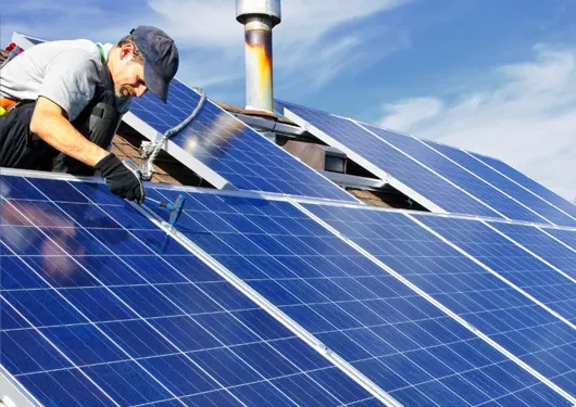 Man Installing Rooftop Solar Panels