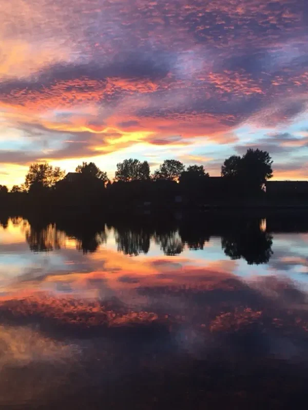 Sunset reflected on still lake water