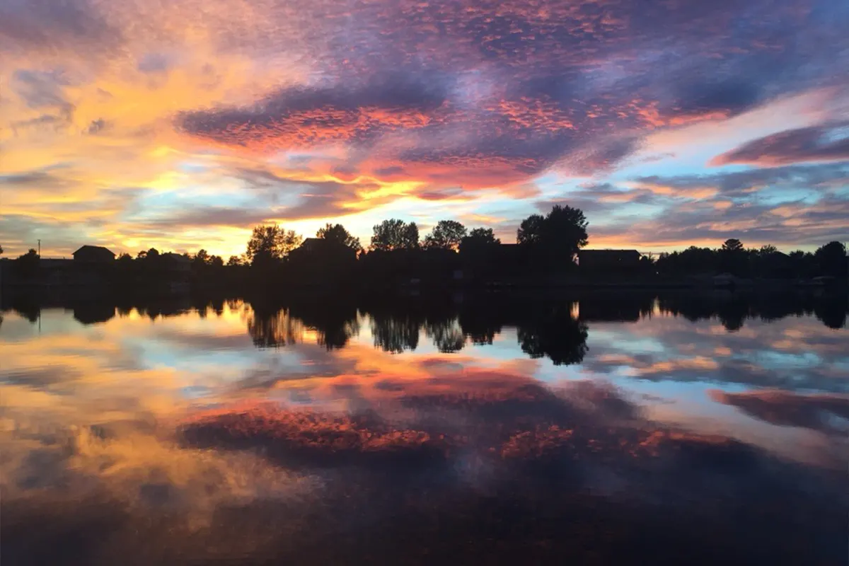 Sunset reflected on still lake water