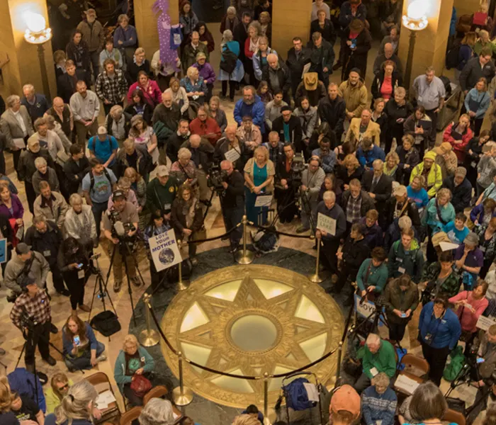 people gathered in the MN Capitol rotunda for a rally