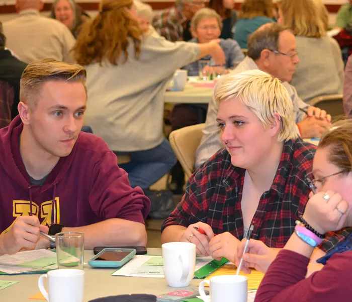 Group of people conversing at a table