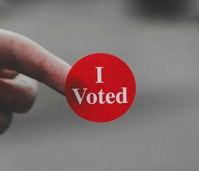 man's hand with I Voted sticker