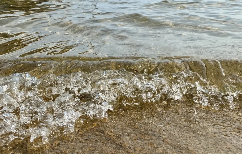 Clear water washing up on a sandy beach