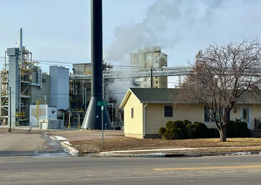 Residential home in front of an industrial plant