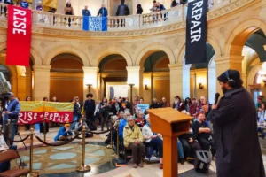 people gathering in the MN state capitol rotunda for Rise + Repair 2025