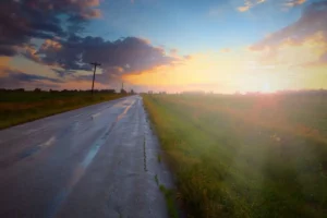 midwestern sunset from a paved road perspective