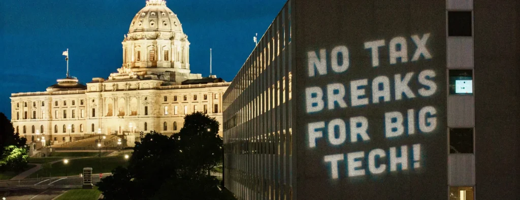 No Tax Breaks For Big Tech projection with MN Capitol in the background